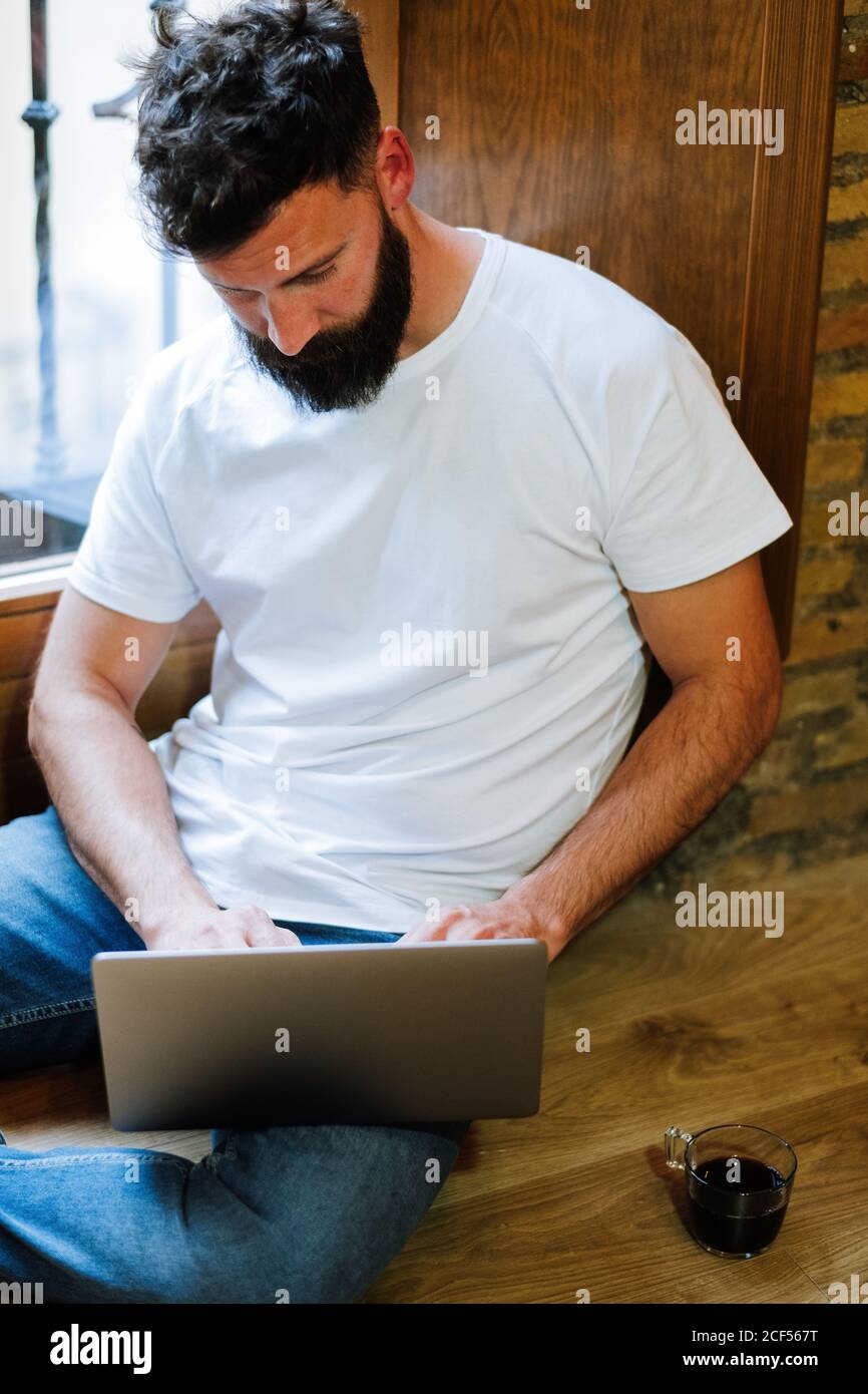 Bearded freelancer using laptop at home Stock Photo