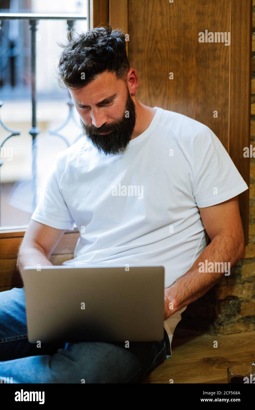 Bearded freelancer using laptop at home Stock Photo