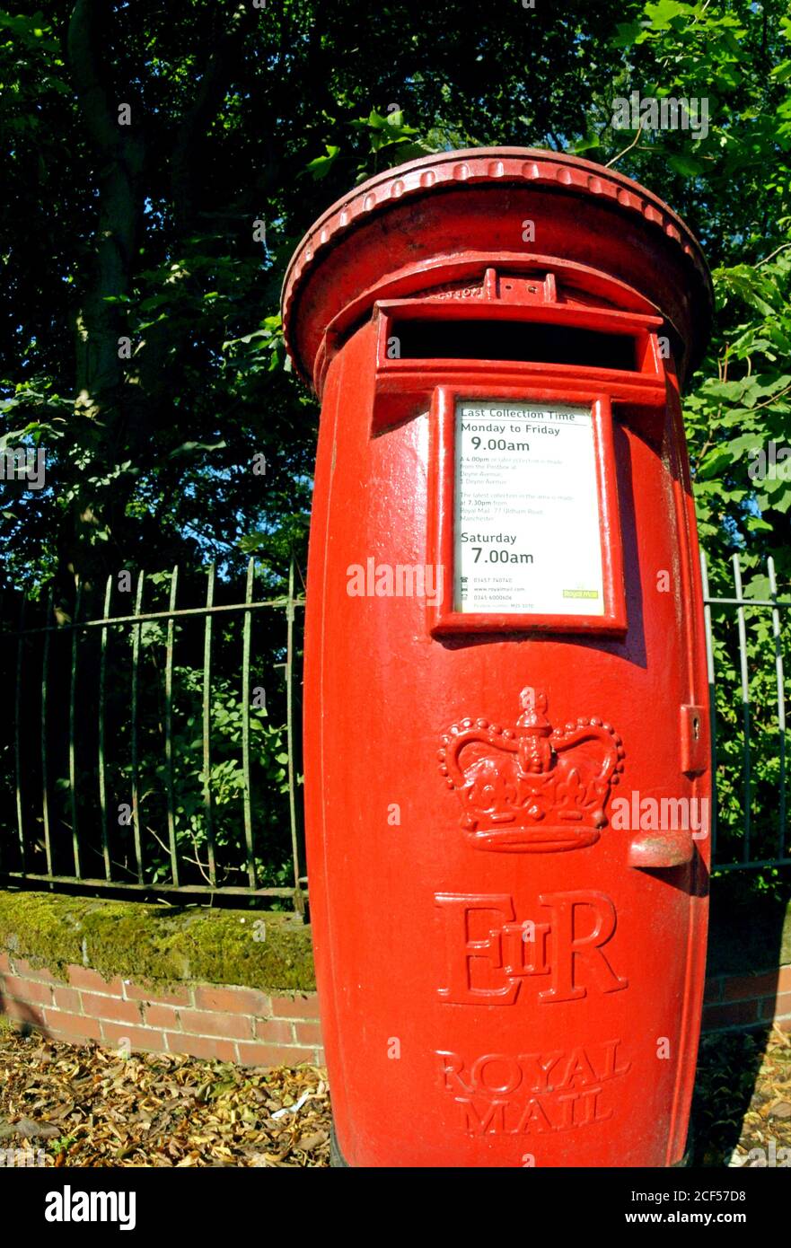 Post Box: bright red, traditional UK Royal Mail (formerly the Post Office)  post box located in Prestwich, Bury, Greater Manchester Stock Photo
