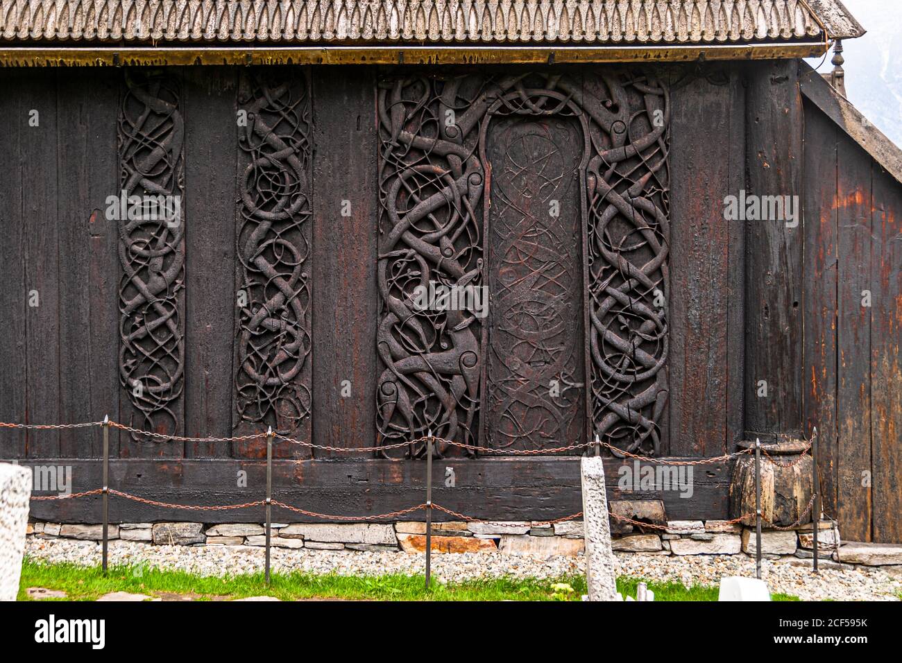 Stave Church Urnes in Luster, Norway. The north portal of the Urnes Stave Church in Luster, Norway is artistically carved after the motif of the world ash tree Yggdrasil. This is also one of the last examples of Viking animal ornamentation Stock Photo