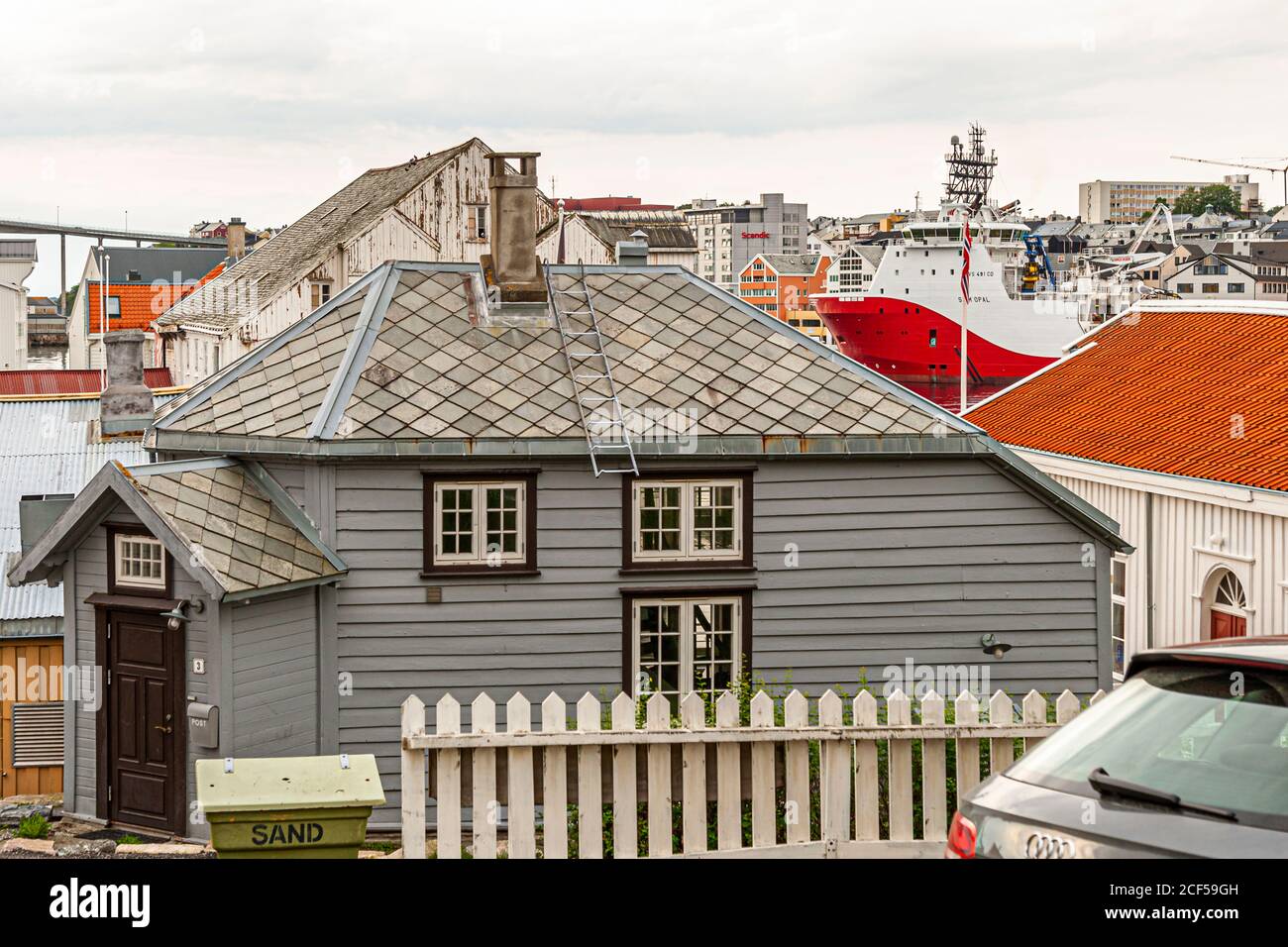 Wooden houses and Fishing trawler in the Sea Harbour of Kristiansund, Norway Stock Photo