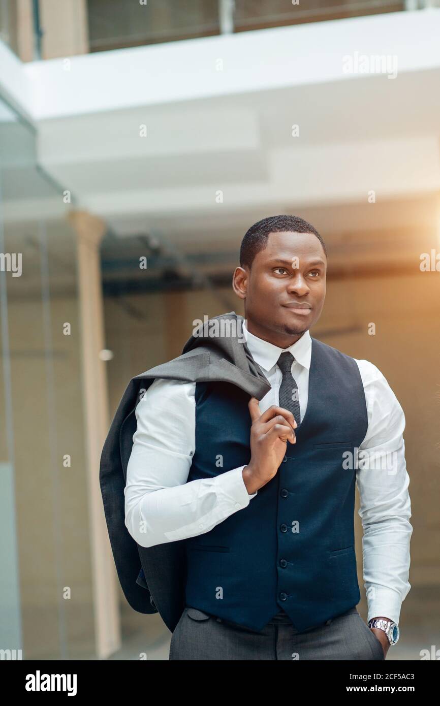 Confident black business man in a stylish suit standing with suit on ...