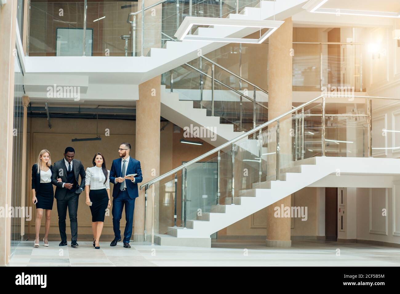 Business people walking in the office corridor Stock Photo - Alamy