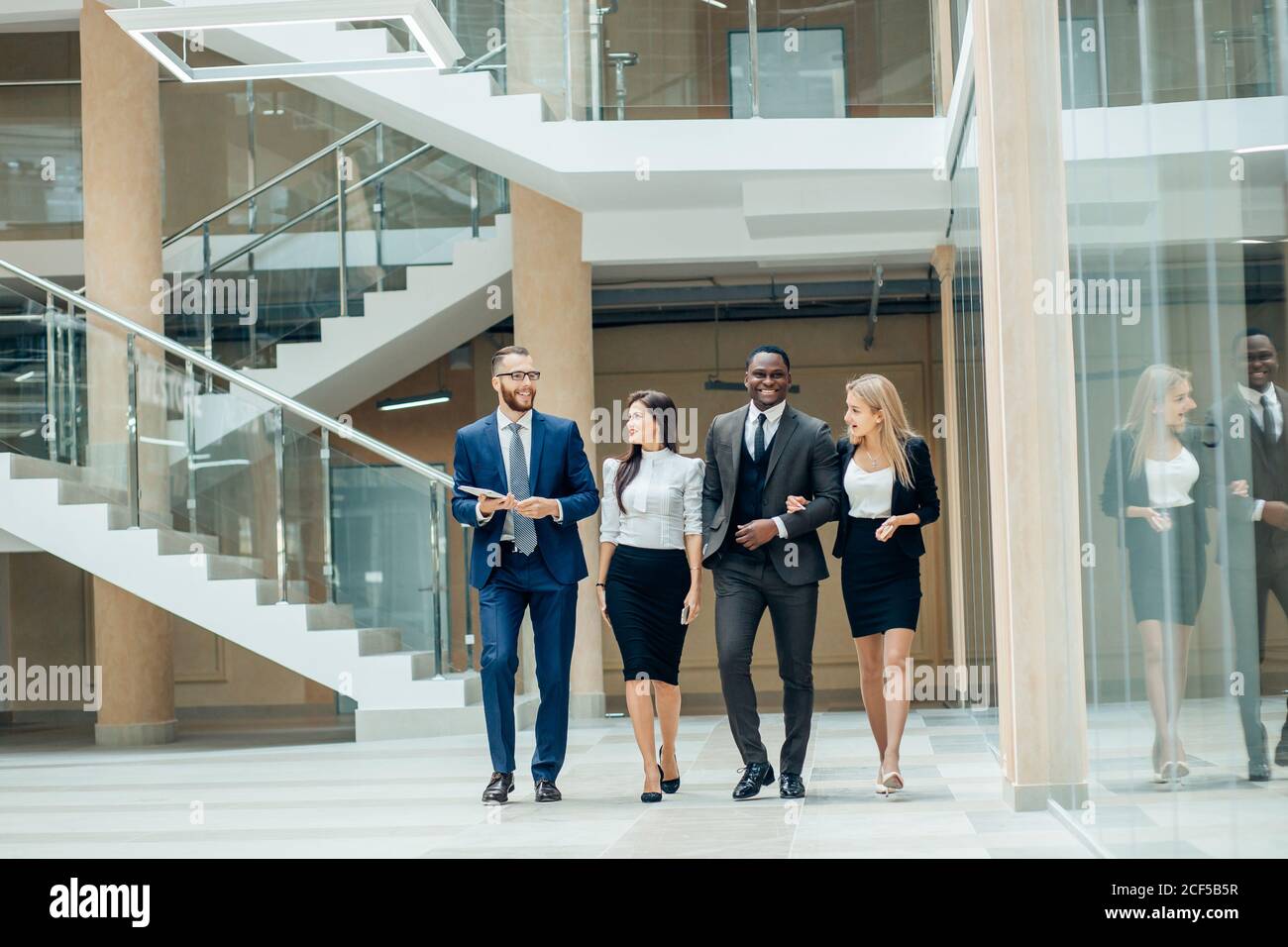 Business people walking in the office corridor Stock Photo - Alamy