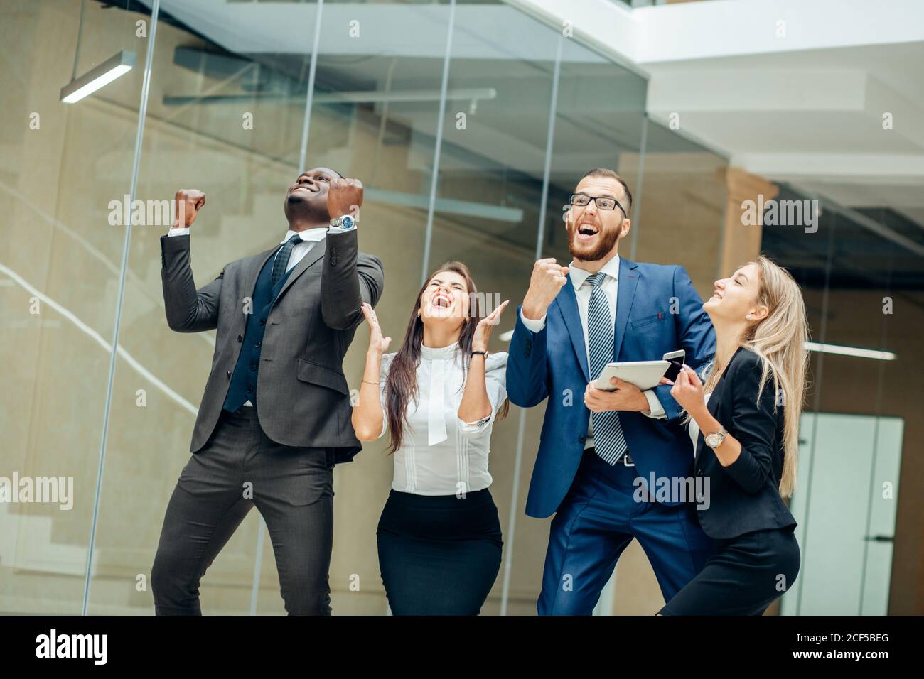 Business team celebrating a triumph with arms up Stock Photo - Alamy