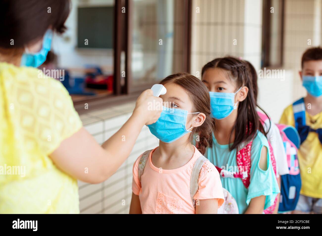 Temperature and medical check at school for covid19 Stock Photo Alamy