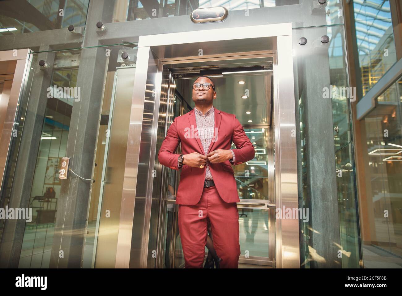black african Business man exit on elevator. Business people in a large