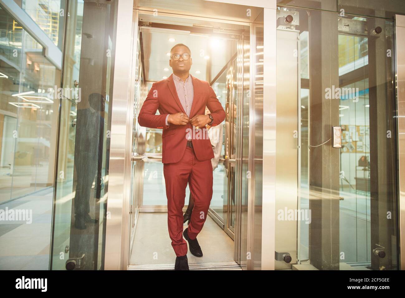 black african Business man going on elevator and talking Stock Photo