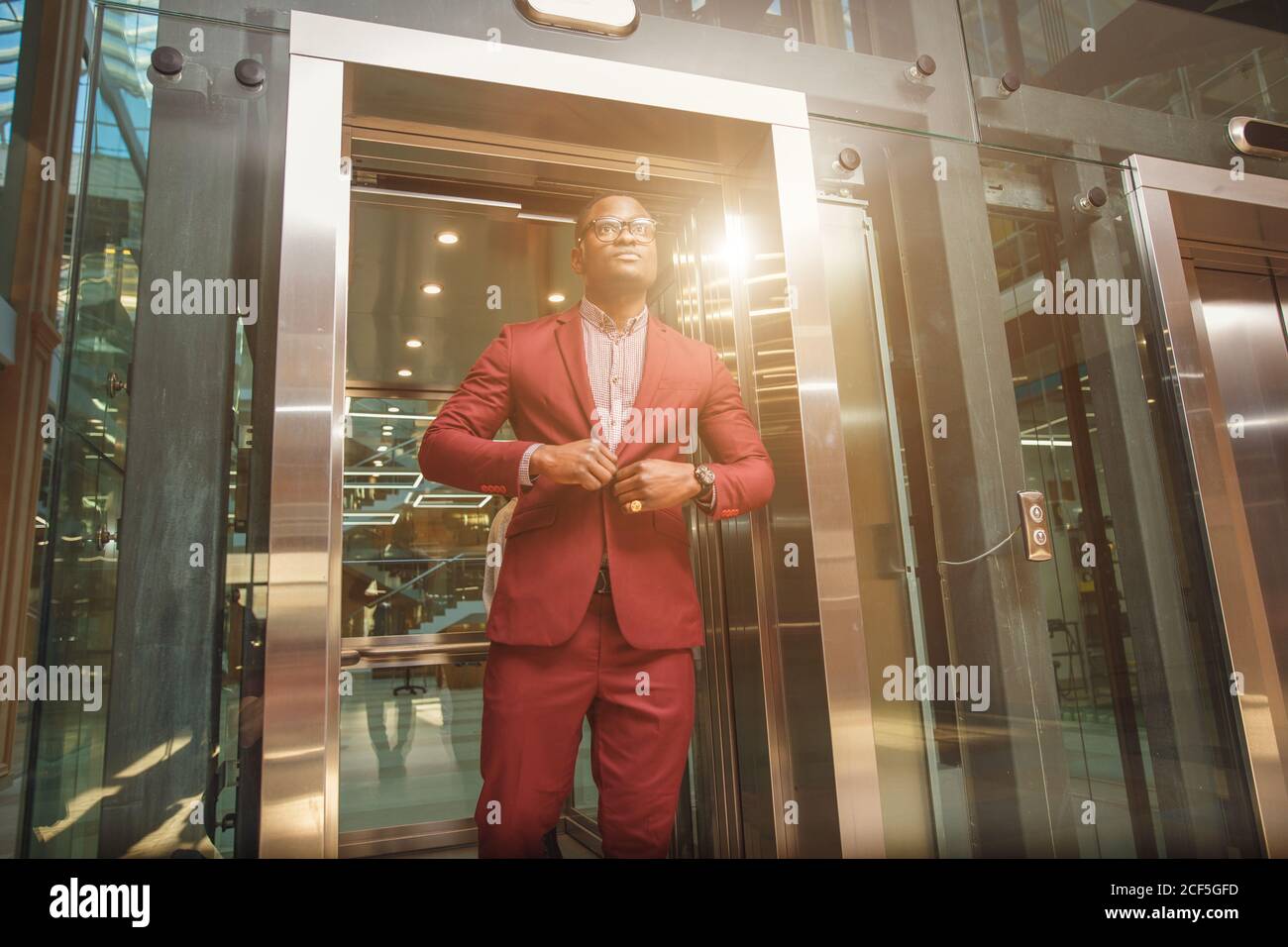 business group comes out from glass Elevator Stock Photo
