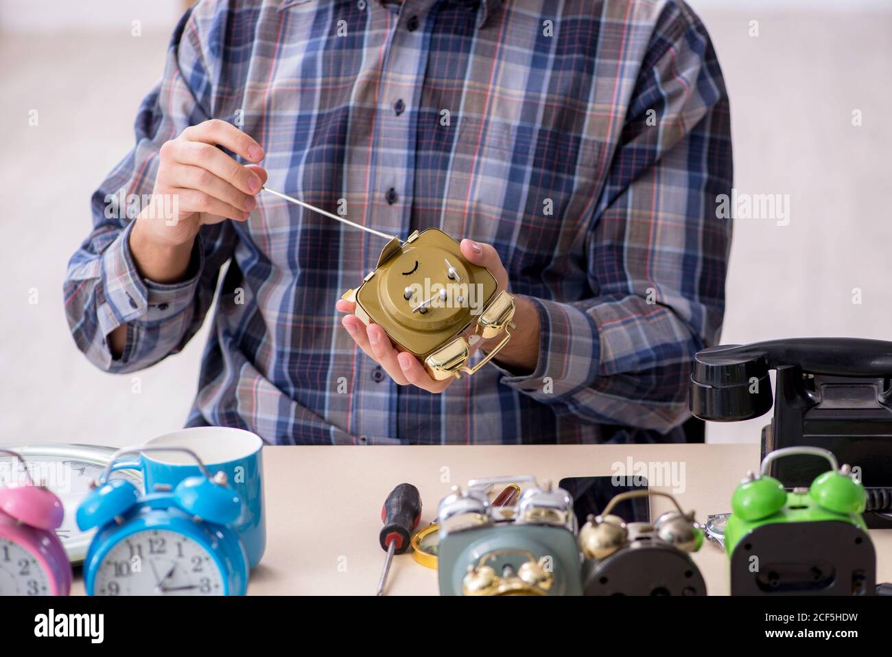 Young watchmaker working in the workshop Stock Photo - Alamy