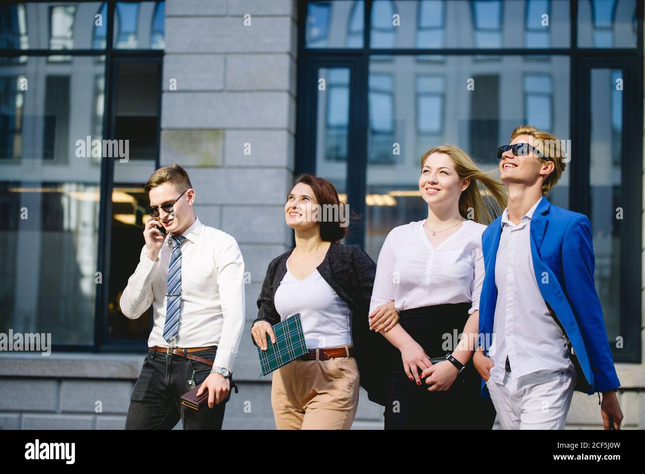 Portrait of friendly business group standing in line Stock Photo - Alamy