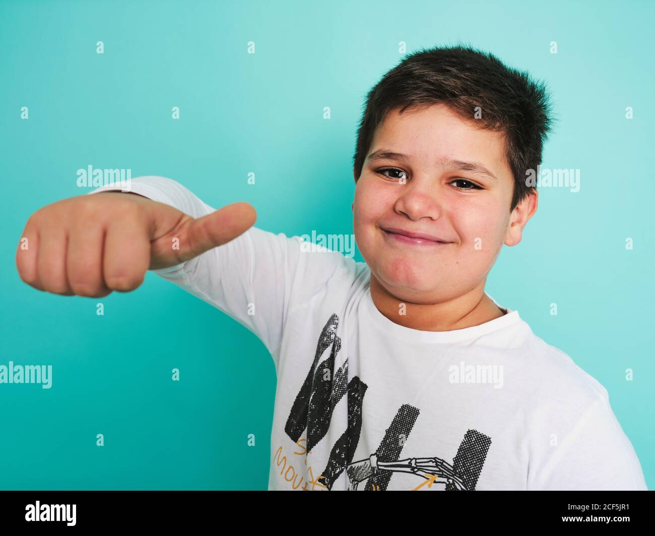 chubby preteen  Joyful confident chubby plus size preteen boy in casual clothes looking at  camera and laughing while gesturing thumbs up against turquoise background  Stock Photo - Alamy