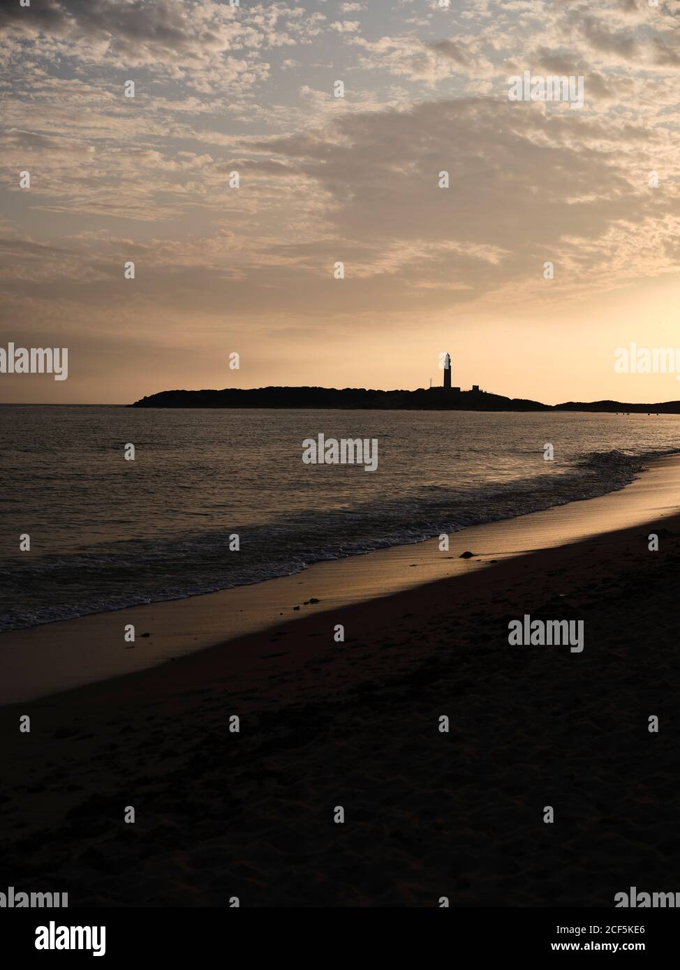 Beautiful sunset over sea with cloudy sky on a beach in the seashore ...