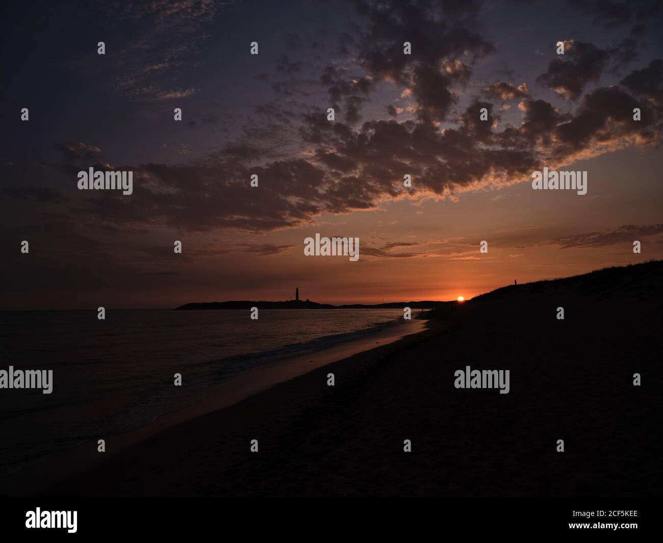 Beautiful sunset over sea with cloudy sky on a beach in the seashore ...
