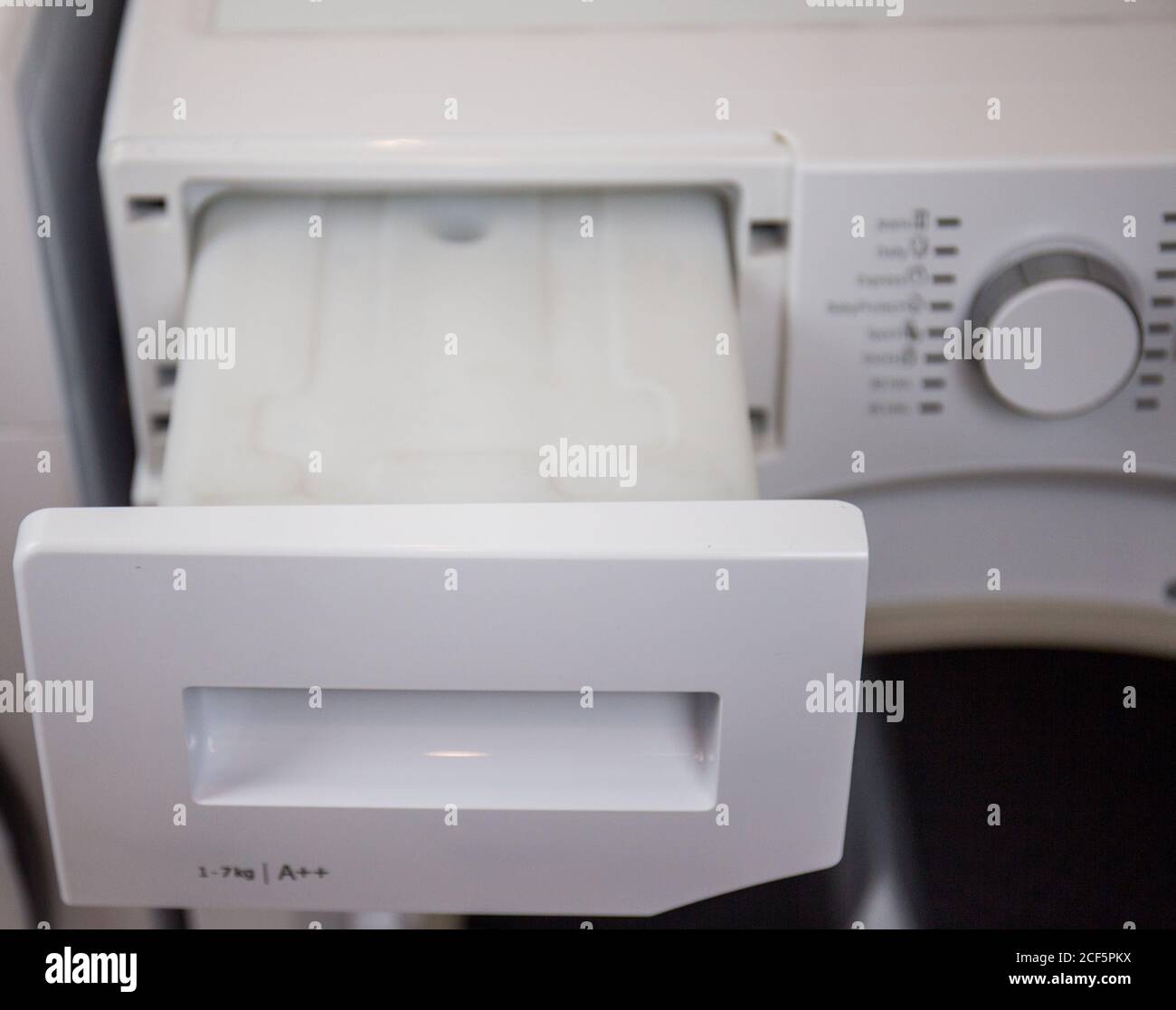 clothes dryer water tank, man maintains the machine regularly, empties