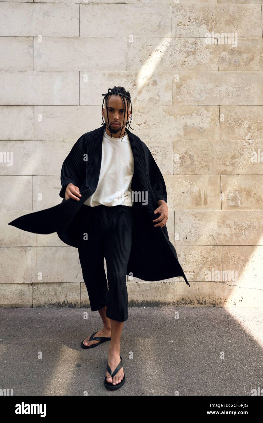 Fashionable young African American male in stylish outfit posing in ...