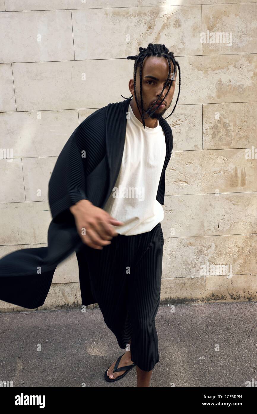 Fashionable young African American male in stylish outfit posing in ...