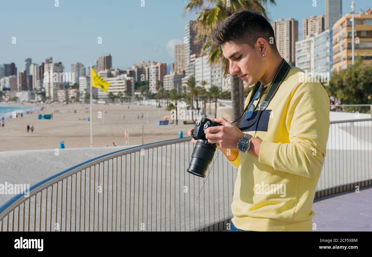 Creative young photographer shooting on waterfront Stock Photo