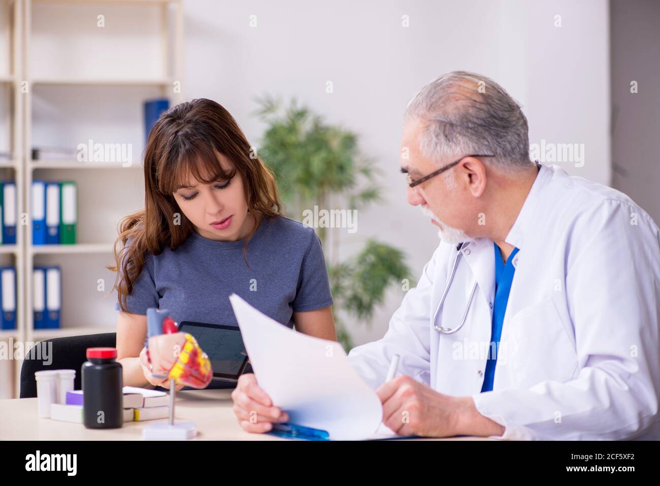 Physician taking pulse young hi-res stock photography and images - Alamy