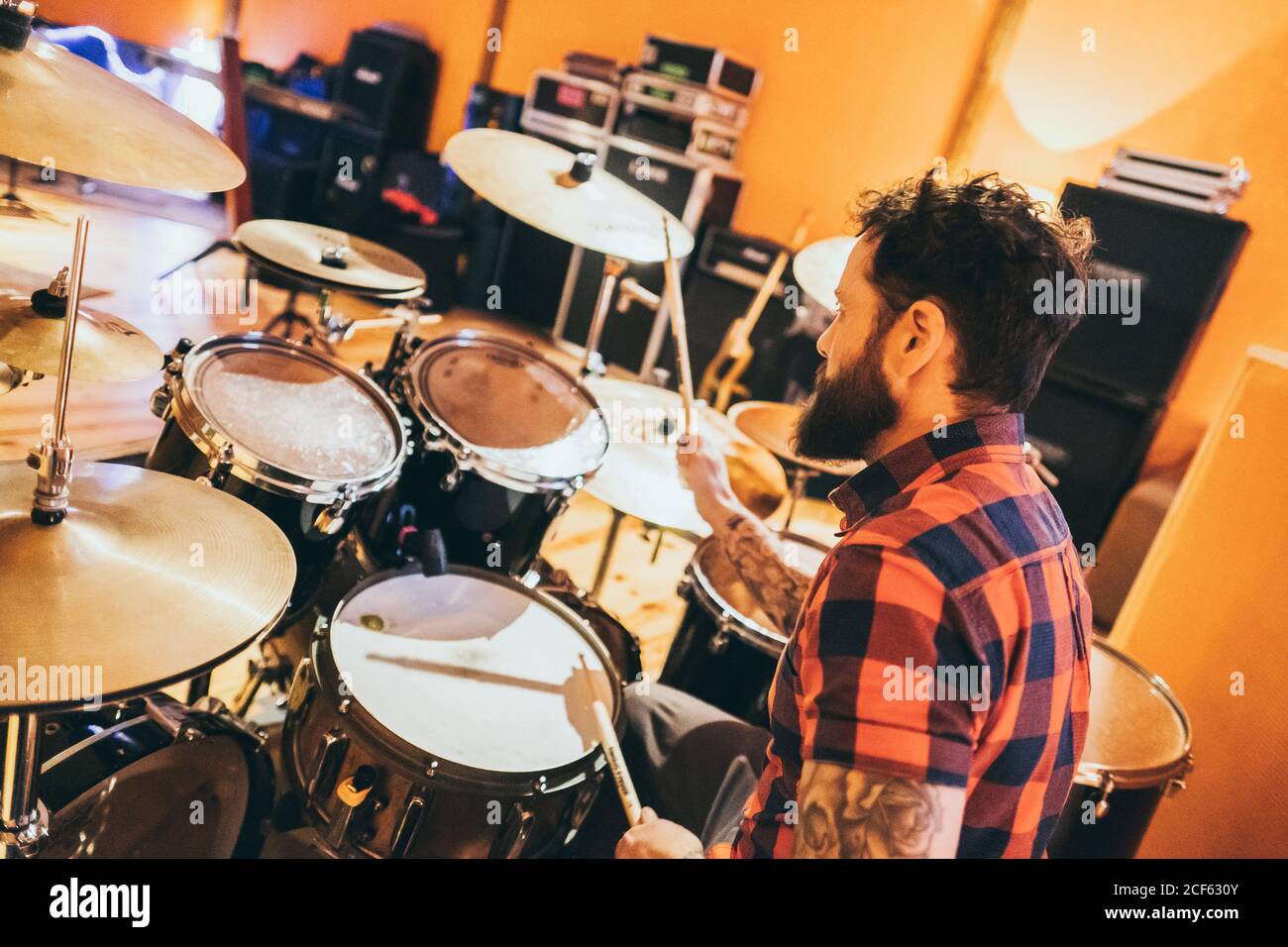 Adult man sitting in music studio playing a drum Stock Photo - Alamy