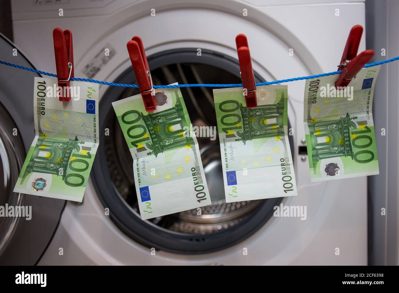 Money attached to a string to dry, symbolically depicted money