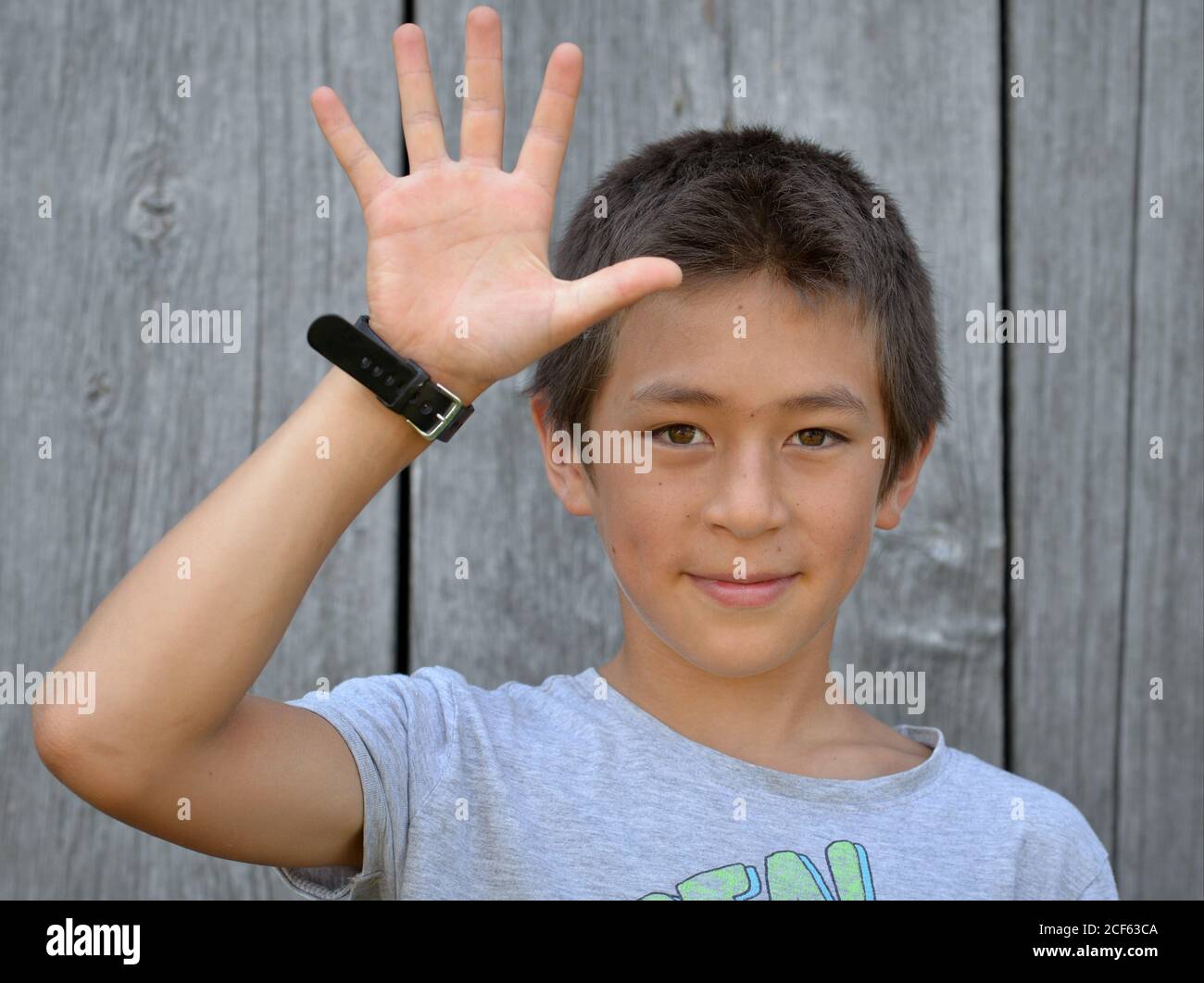 Mixedrace preteen boy (East Asian and Caucasian) shows with his right