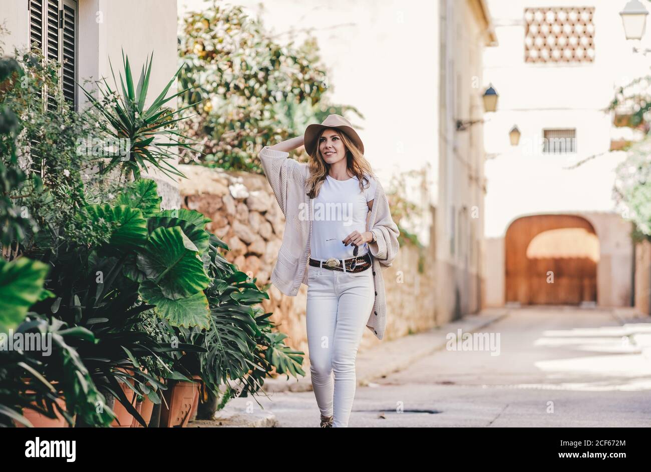 Stylish woman walking side view hi-res stock photography and