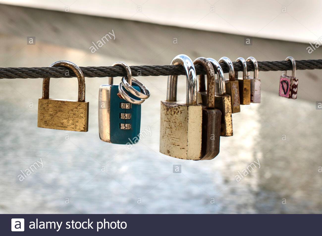 Love locks tied on a bridge as a symbol of eternal love Stock Photo - Alamy