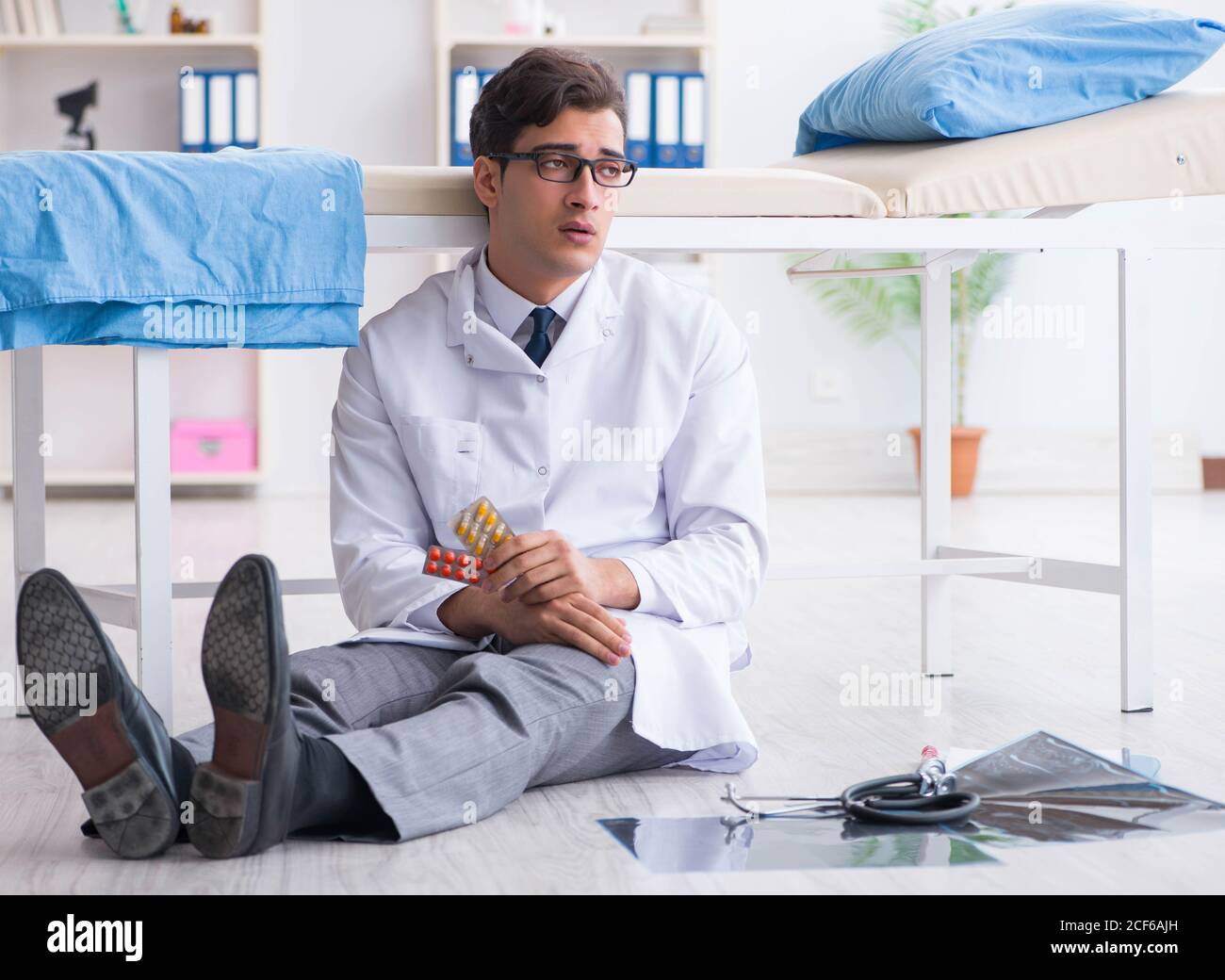 The doctor sitting on the floor in hospital Stock Photo - Alamy