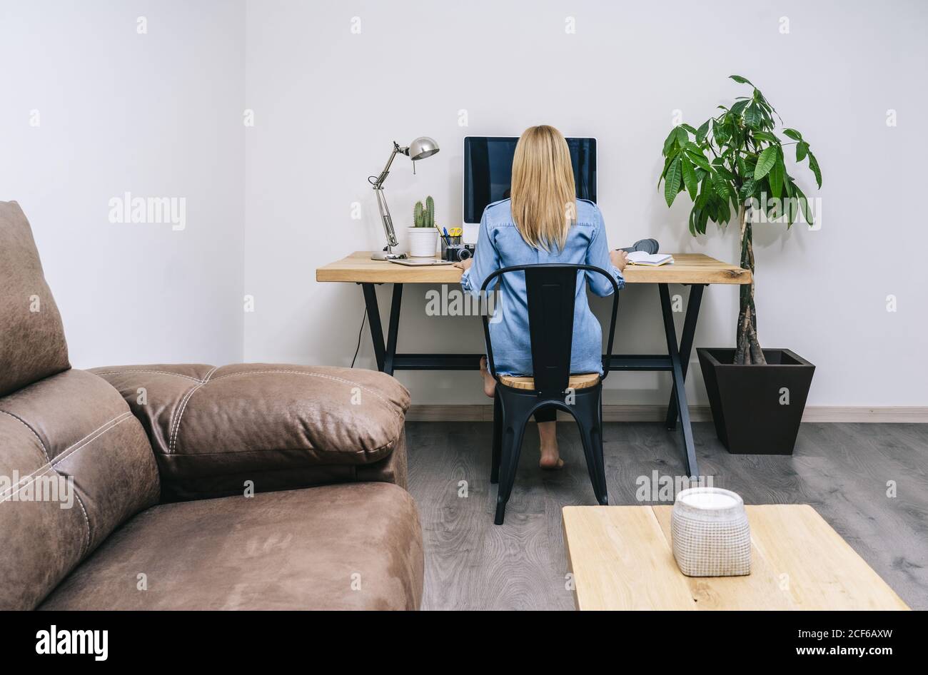 Blonde Caucasian Woman works from her home office Stock Photo