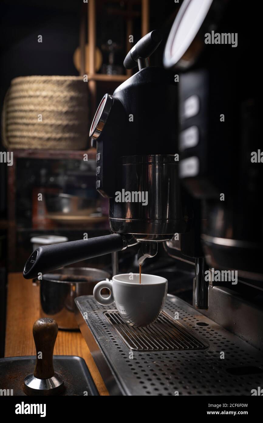 Barista making coffee using a coffee maker Stock Photo Alamy