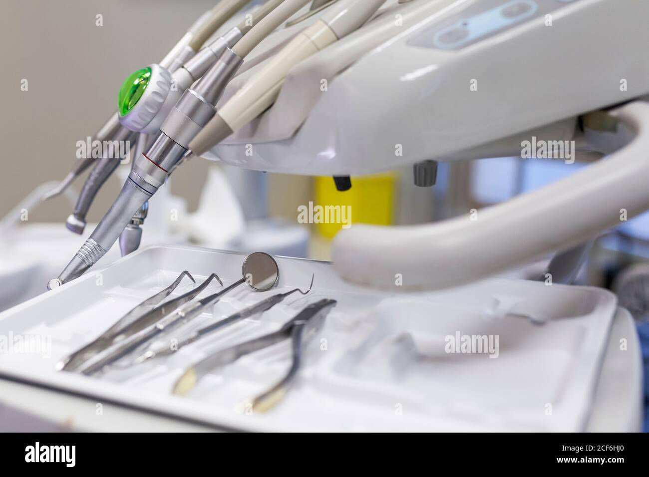 Dentist steel tools like sharp, scraper, carver, drill and mirror in tray on table in dental cabinet in clinic Stock Photo