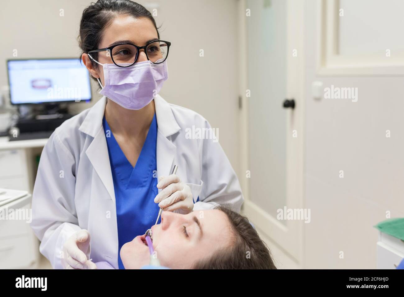 Woman dentist attending to a patient Stock Photo