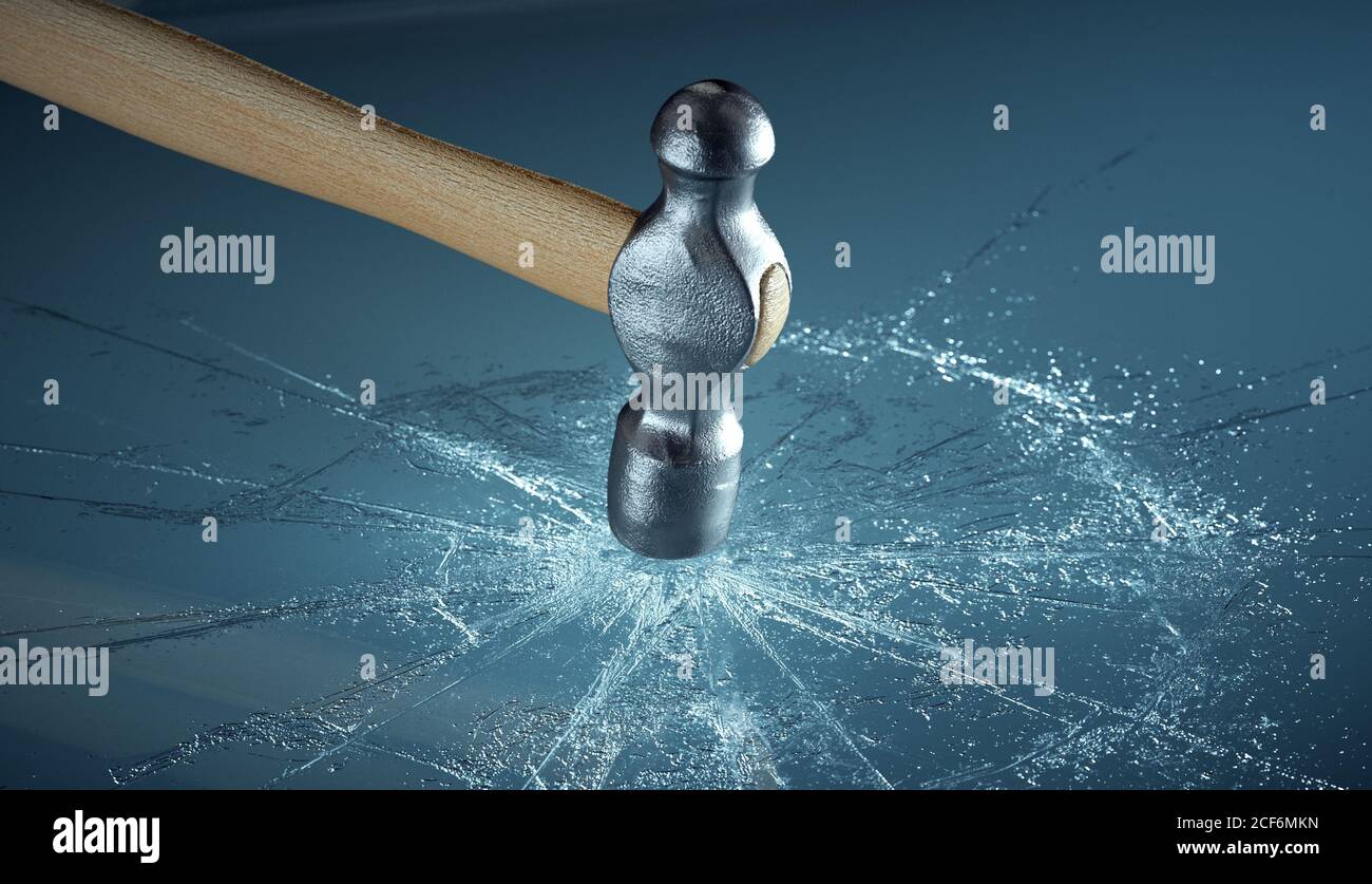 Hammer hitting glass, shattering it Stock Photo Alamy