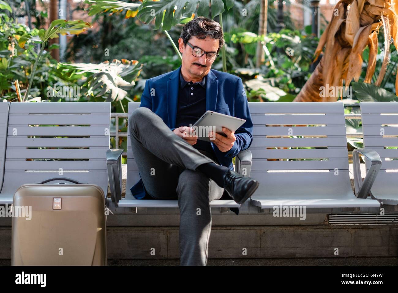 Aged handsome man using digital tablet outdoors Stock Photo