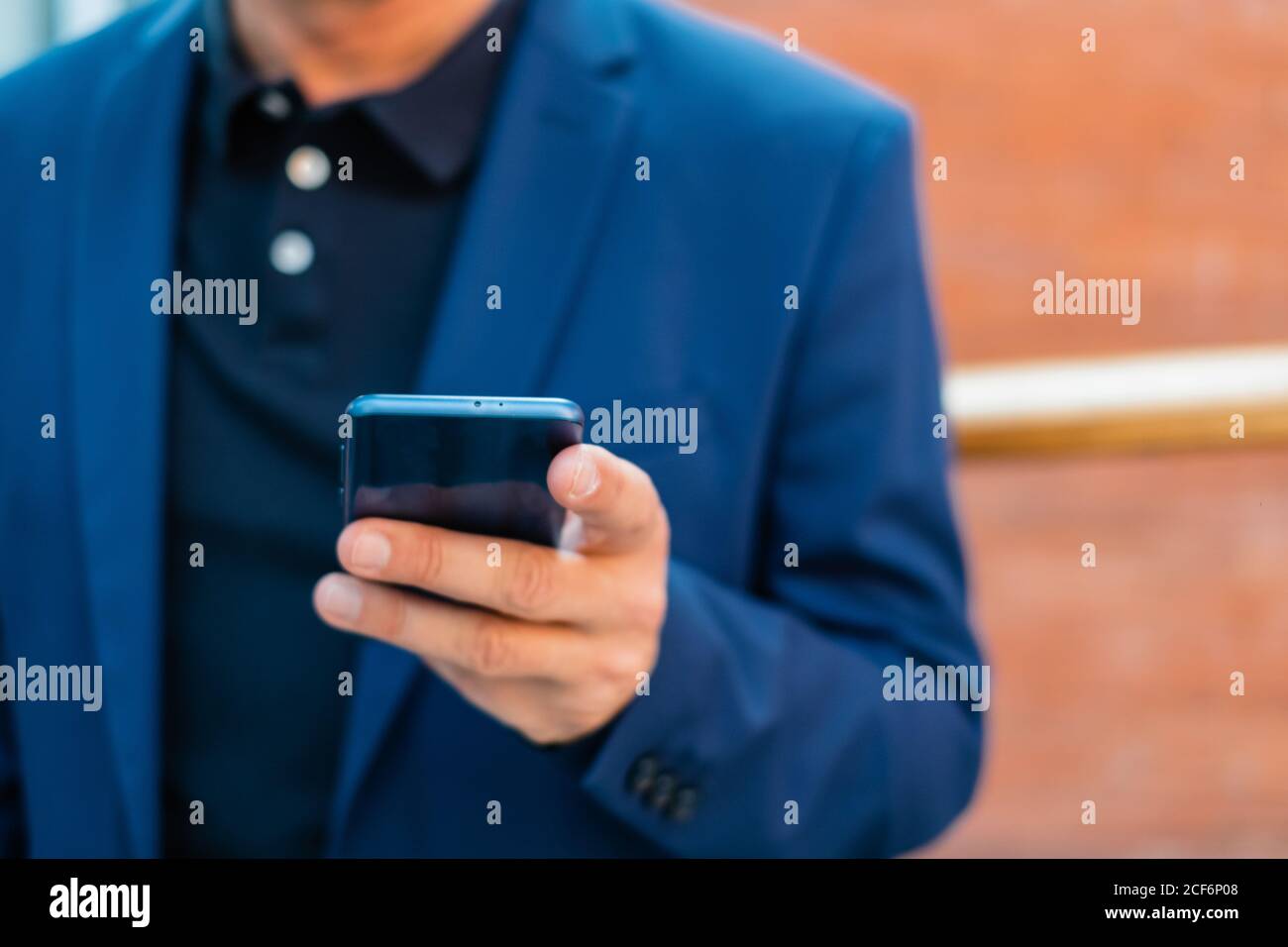 Senior businessman in blue jacket using smartphone Stock Photo