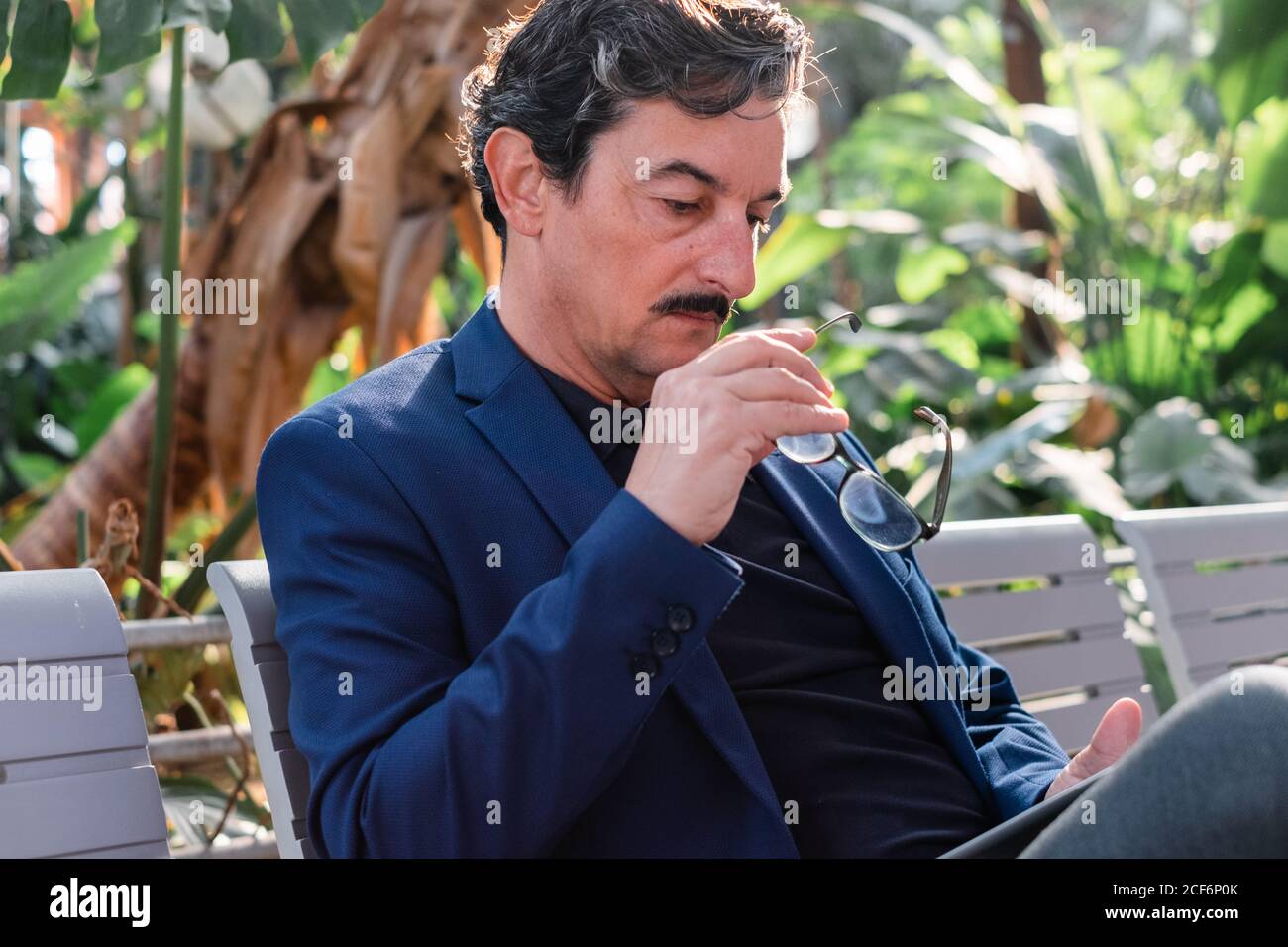 Aged handsome man using digital tablet outdoors Stock Photo