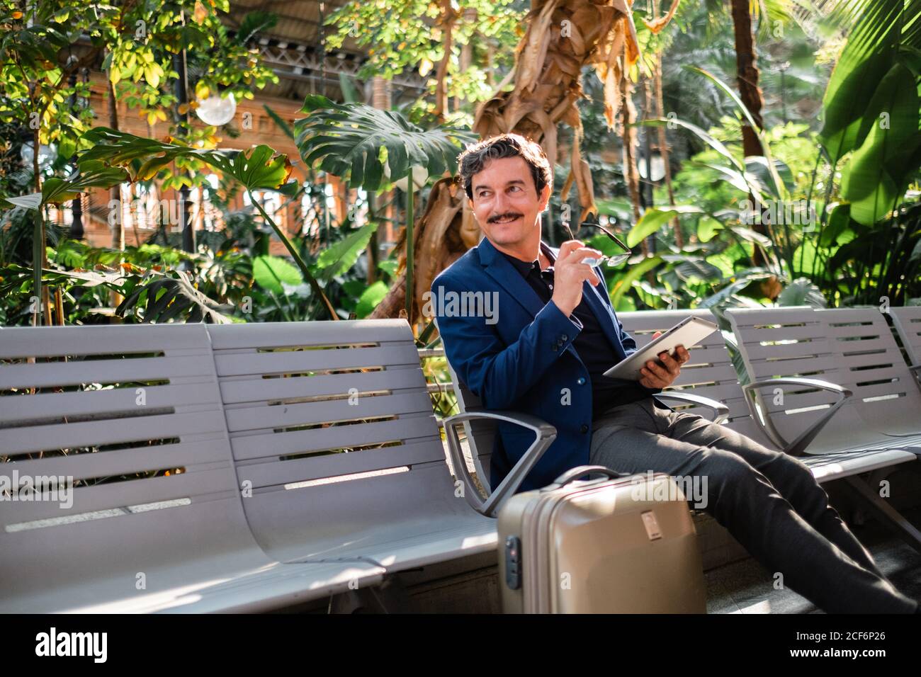 Aged handsome man using digital tablet outdoors Stock Photo