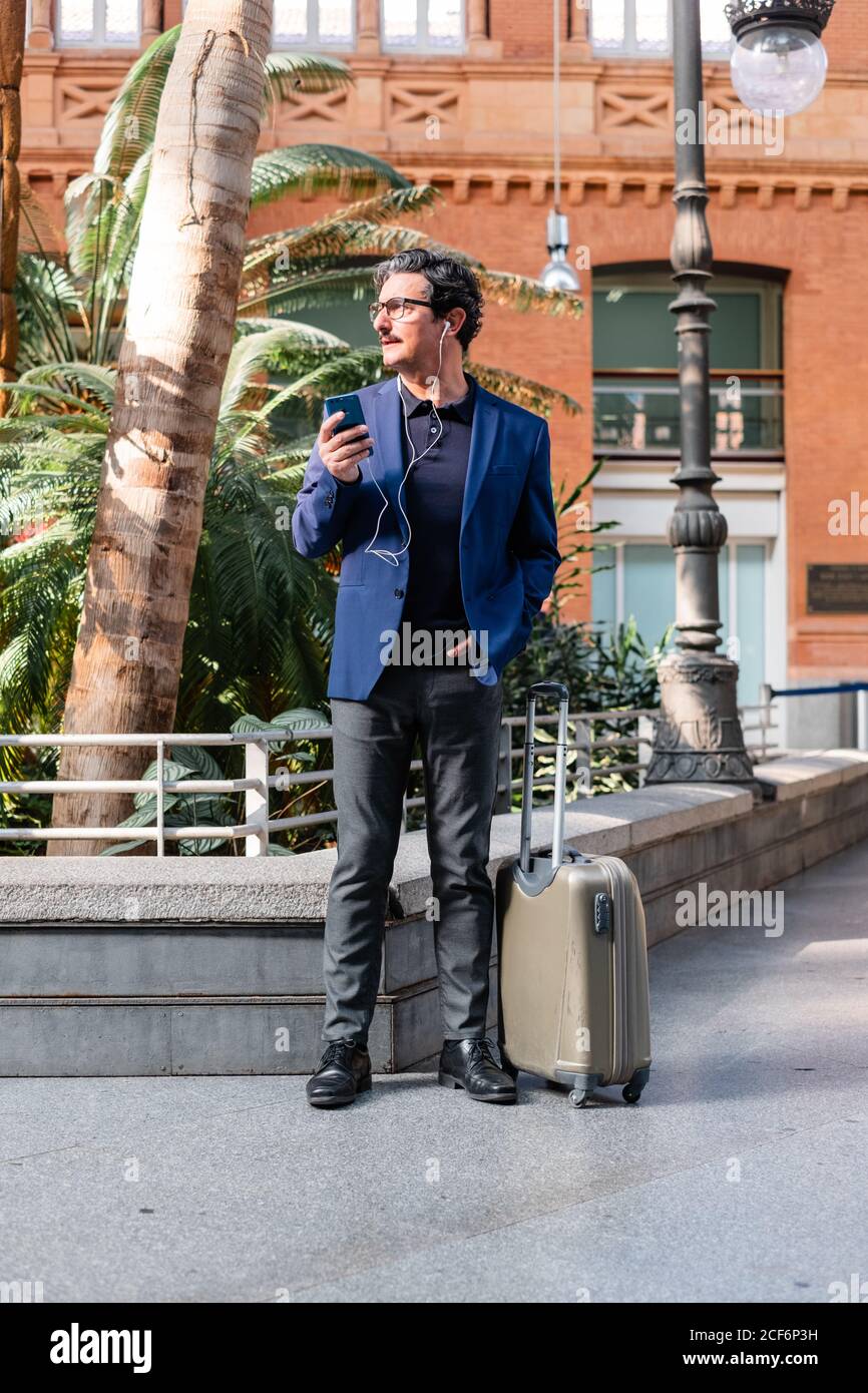 Senior businessman in blue jacket using smartphone Stock Photo