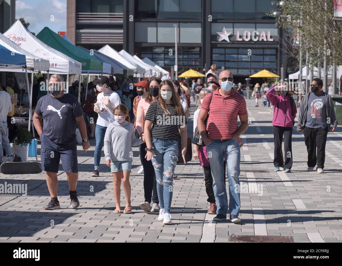 Lansdowne Farmers Market in Ottawa: People walking around area with majority wearing face masks keeping distance  buying produce Stock Photo