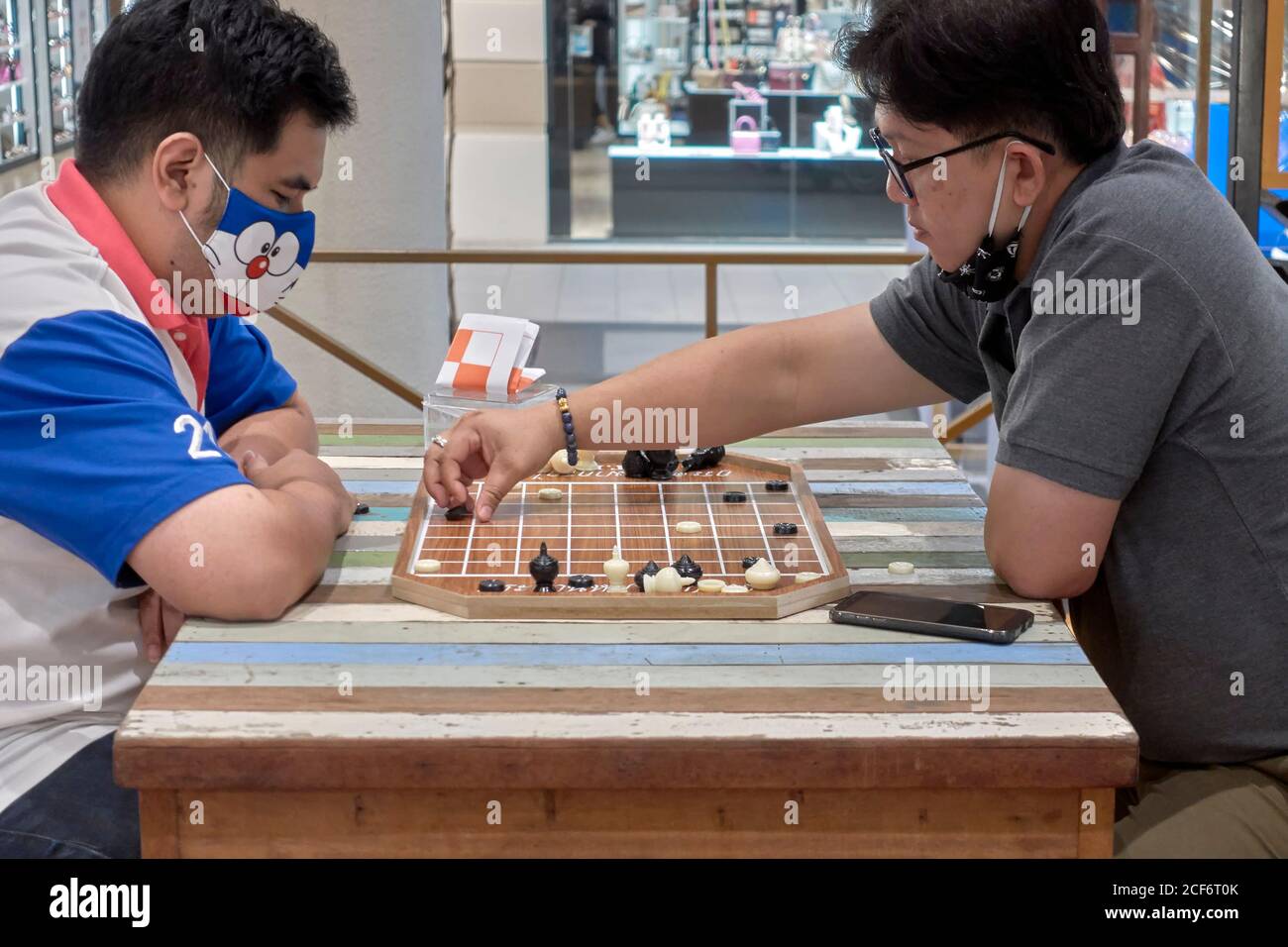 Local Thai people play old traditional Thai chess in public area - slow  life style local people with chess board game concept Stock Photo