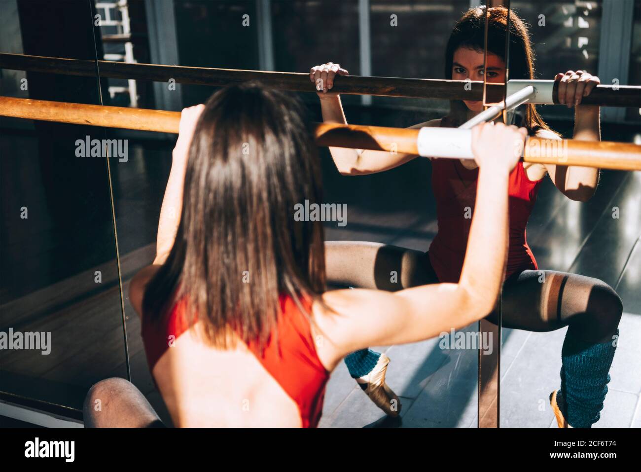 Concentrated dancer training with barre Stock Photo