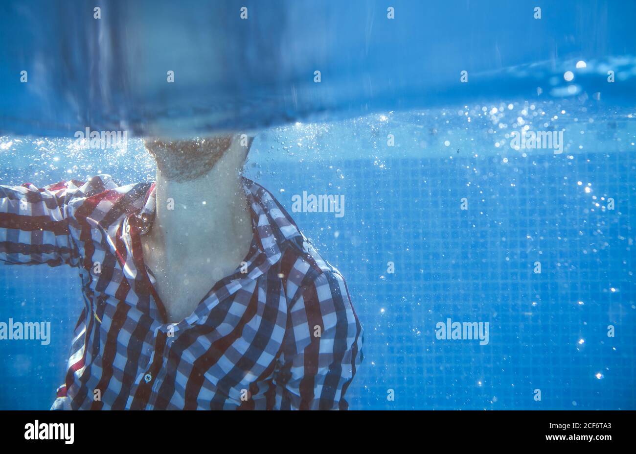 Dressed man in swimming pool Stock Photo