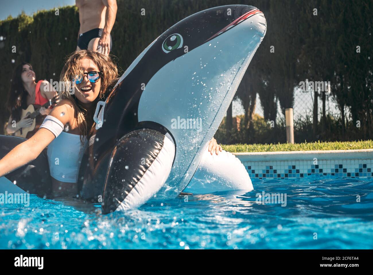 girl floating over an inflatable killer whale Stock Photo Alamy