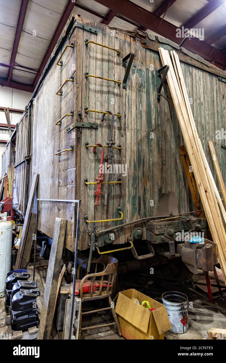 An antique wooden railway boxcar is under repair inside the Fort Wayne Railroad Historical Society workshop in New Haven, Indiana, USA. Stock Photo