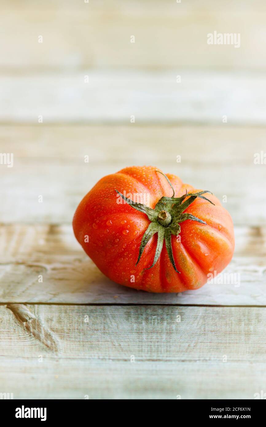 View of beautiful red heirloom tomato on wooden background Stock Photo