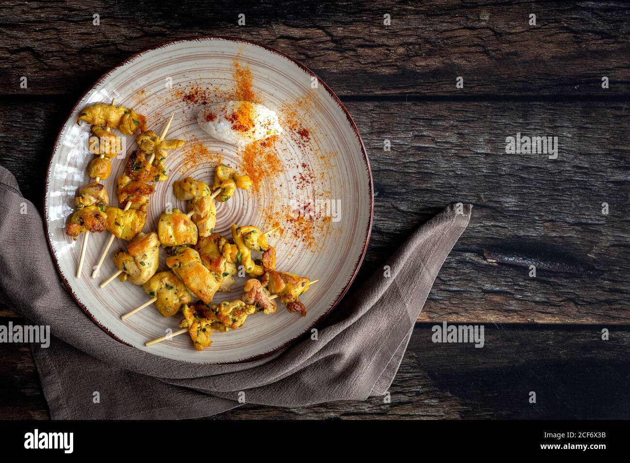 Homemade Moorish skewers with rice of meat with spices. Typical oriental food from above on wood background. Flat lay. Top view Stock Photo