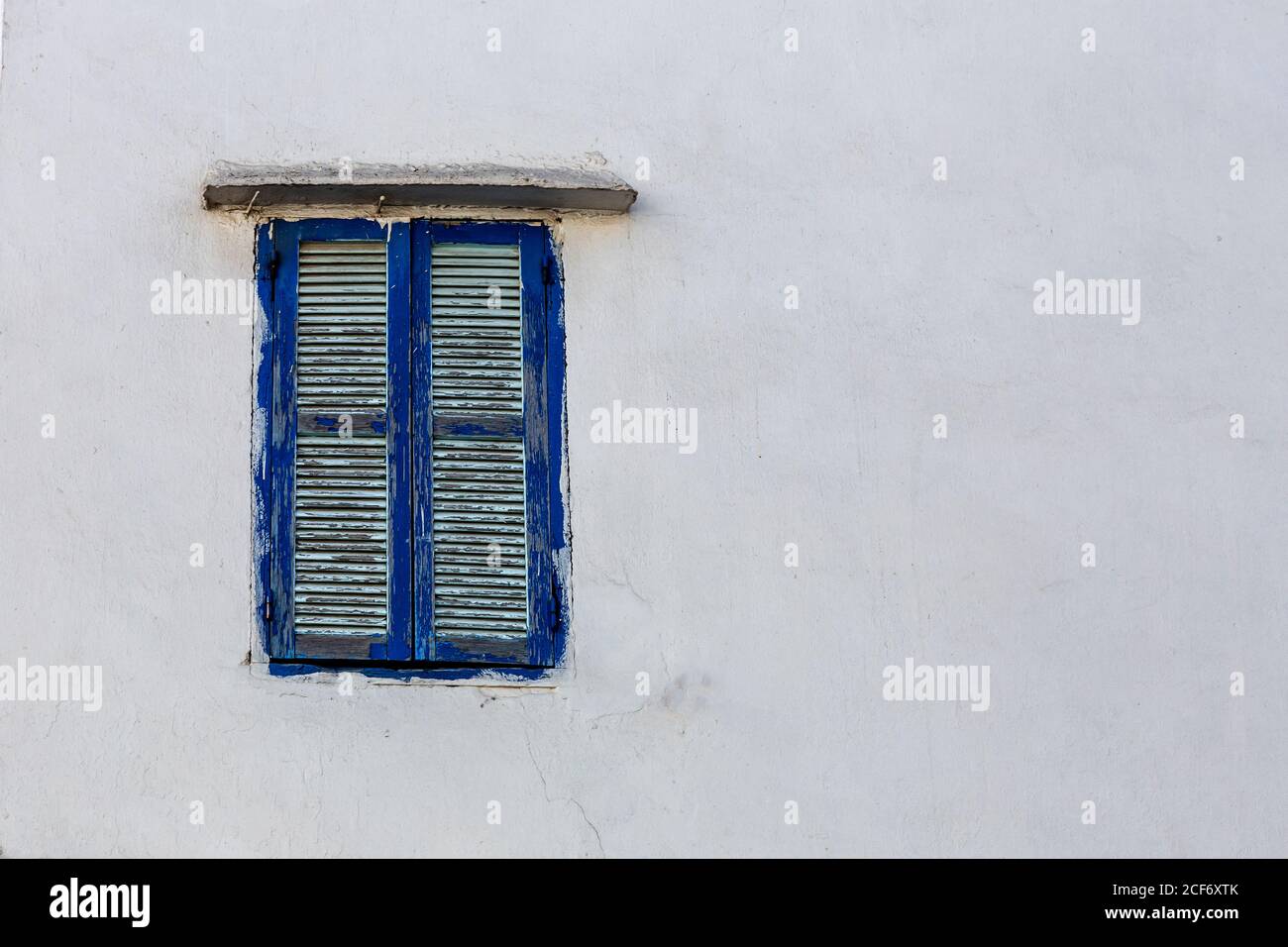Blue window shutters on white concrete wall of house in Tangier, Morocco Stock Photo