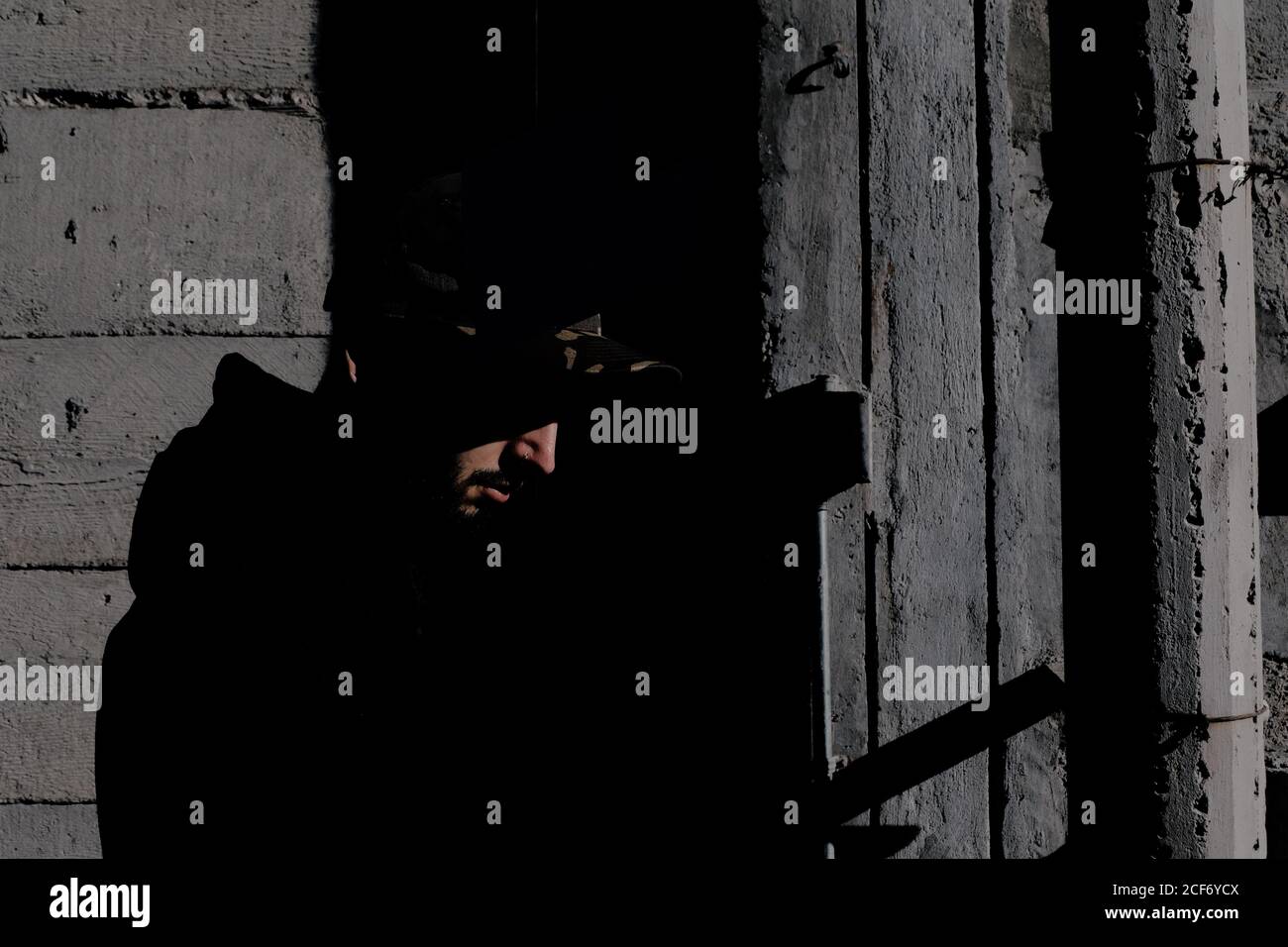 Modern guy inside desolate building Stock Photo - Alamy