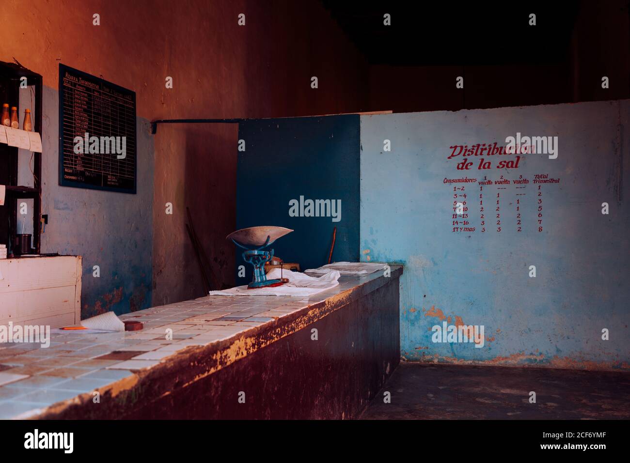 Abandoned cafe with bar counter painted menu and empty shelves on blue